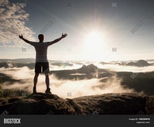 man on top of mountain